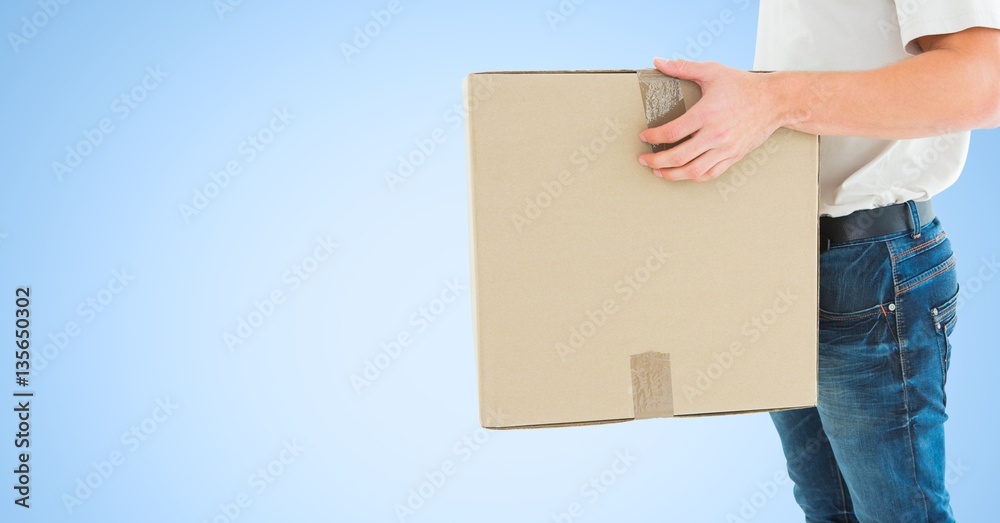 Delivery man with box against blue background