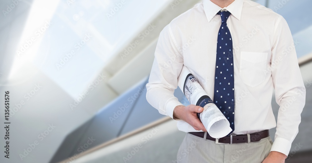 Businessman holding blueprint