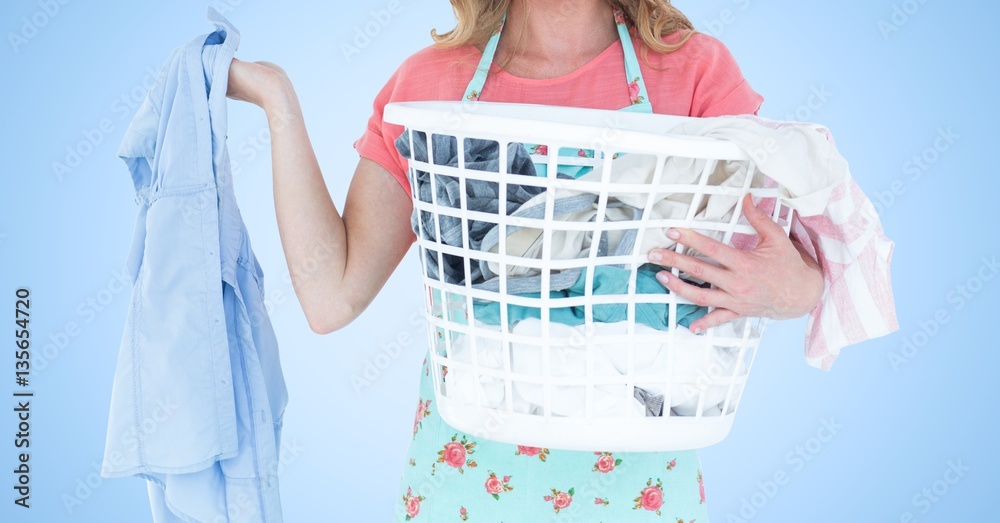 Woman holding a basket full of clothes