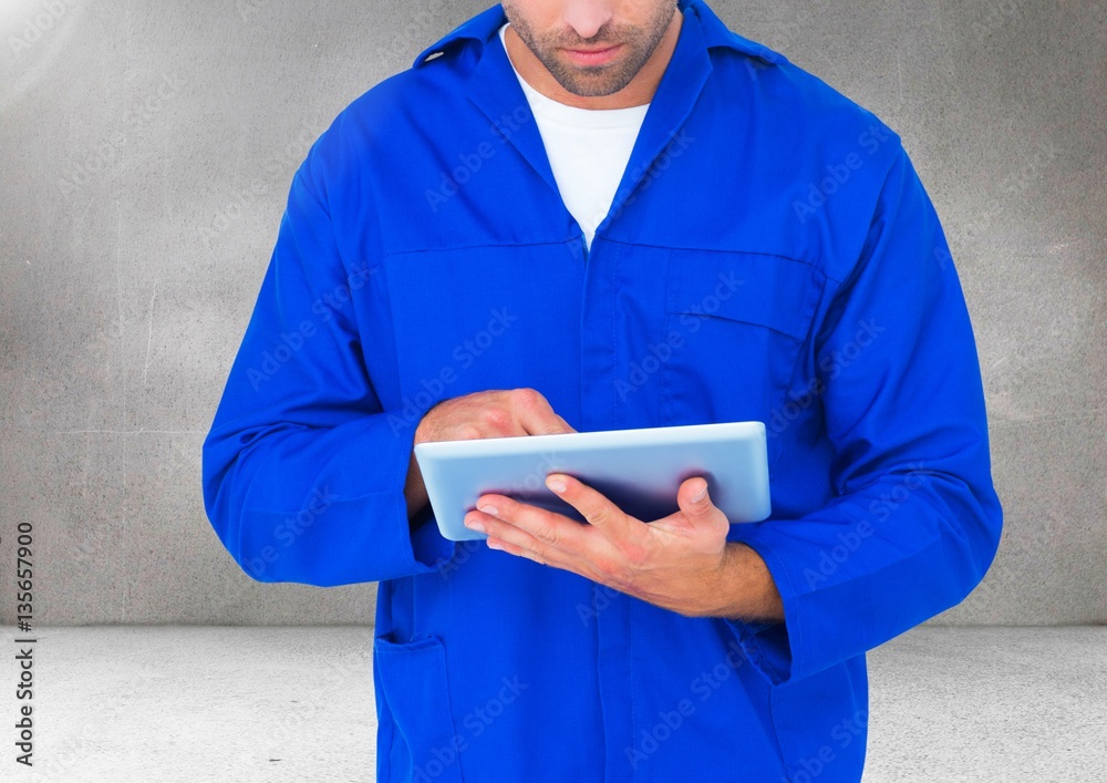 Composite image of car mechanic using digital tablet