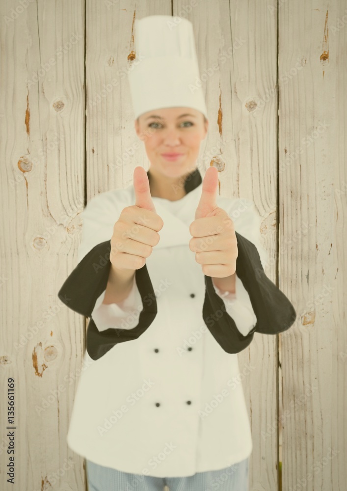 Portrait of female chef showing thumbs up