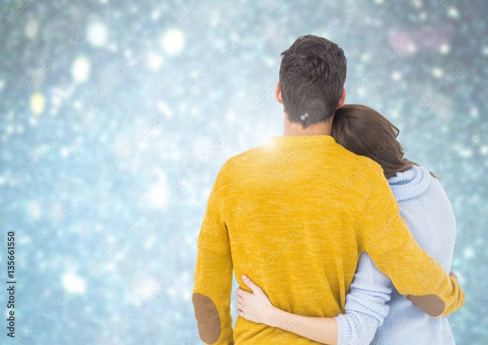 Couple embracing each other against bokeh background