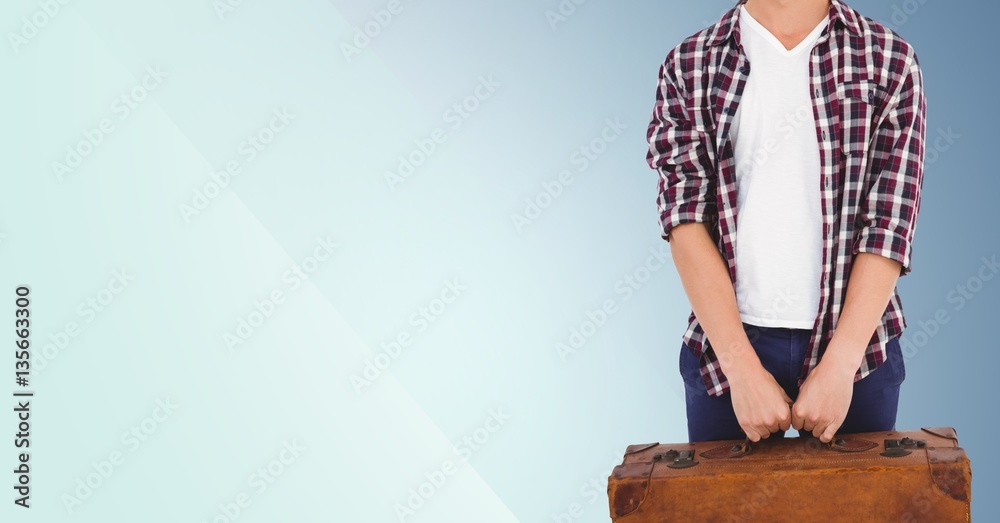 Man with suitcase standing against blue background