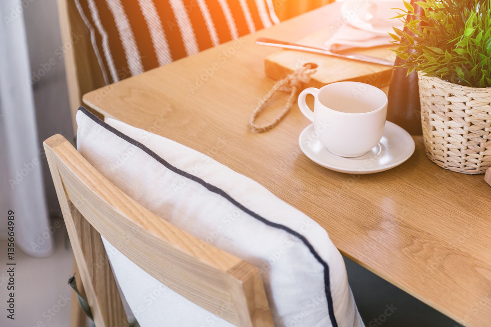 set of tea or coffee with small teapot on wooden table with room