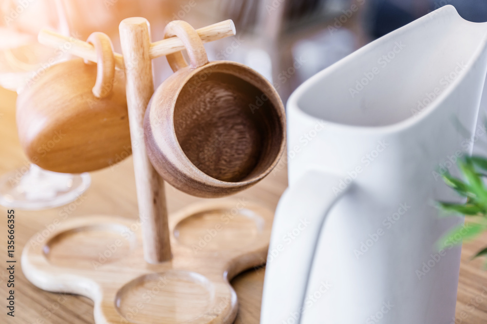 set of tea or coffee with small teapot on wooden table with room