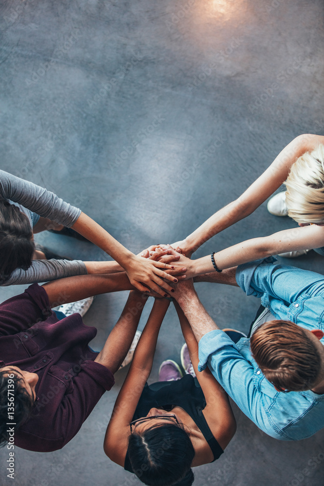 Stack of hands symbolizing trust and cooperation