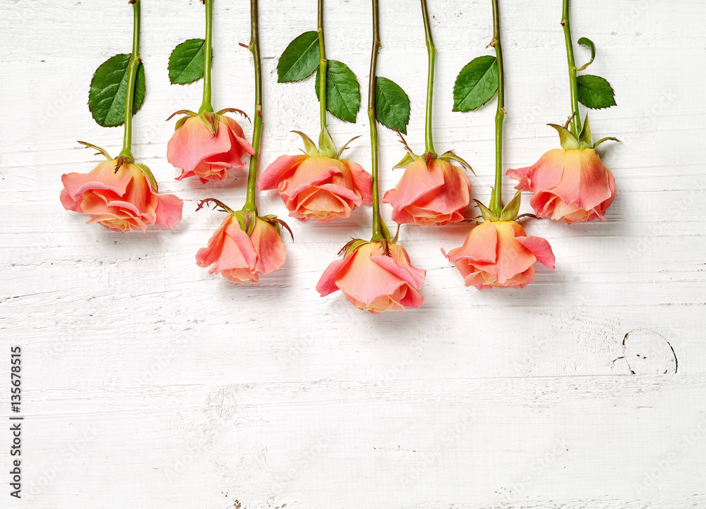 pink roses on white wooden table