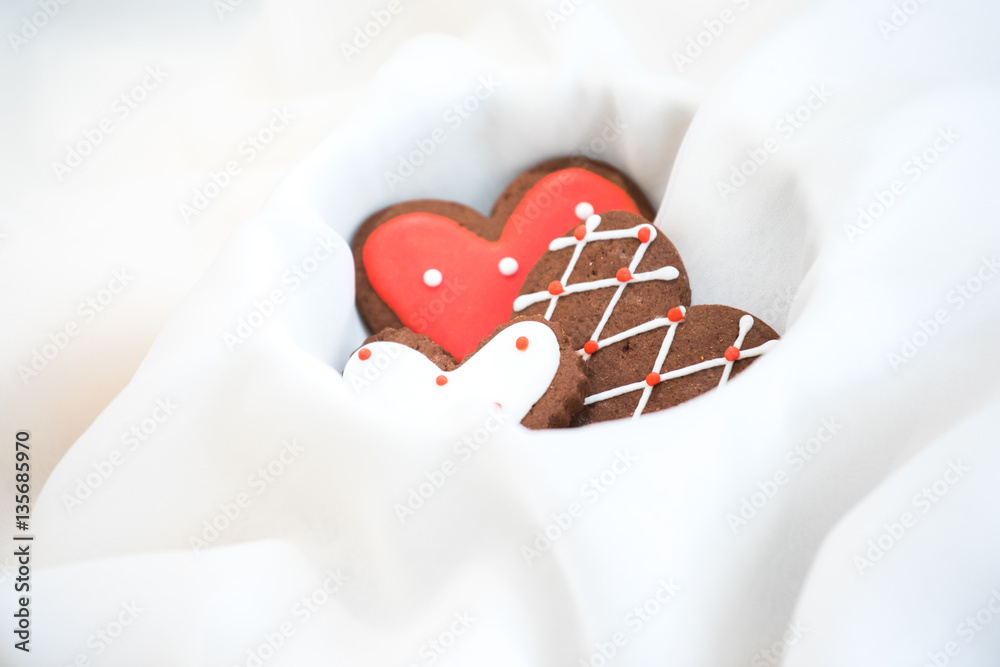 Heart shaped chocolate Valentines Day cookies with red and white glaze.