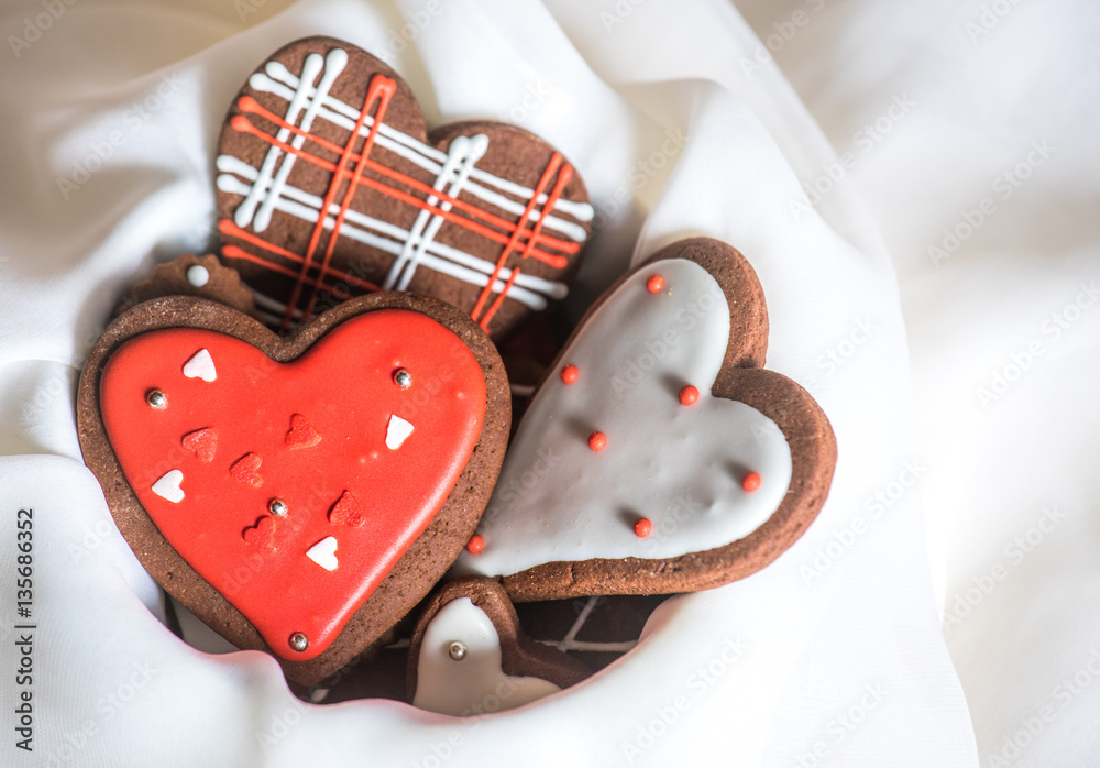 Heart shaped chocolate Valentines Day cookies with red and white glaze.