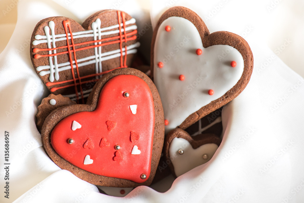 Heart shaped chocolate Valentines Day cookies with red and white glaze.