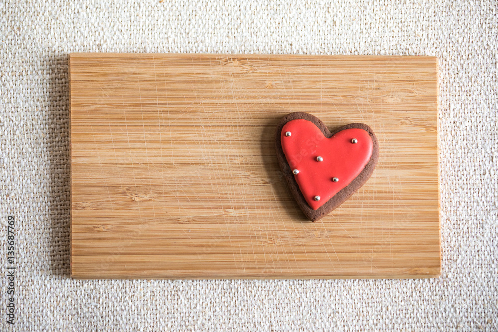 Heart shaped chocolate Valentines Day cookies with red and white glaze.