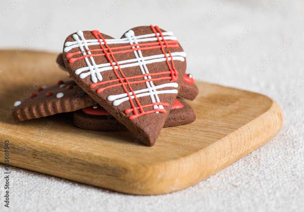 Heart shaped chocolate Valentines Day cookies with red and white glaze.