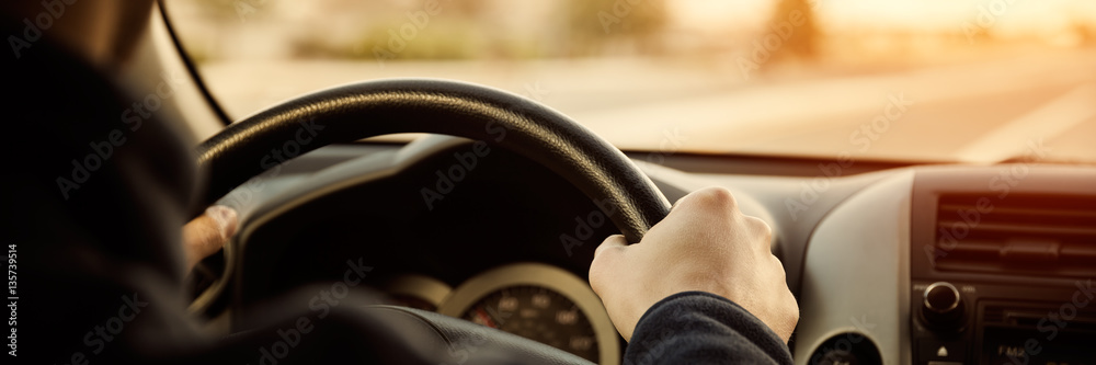 Driving car hands on steering wheel