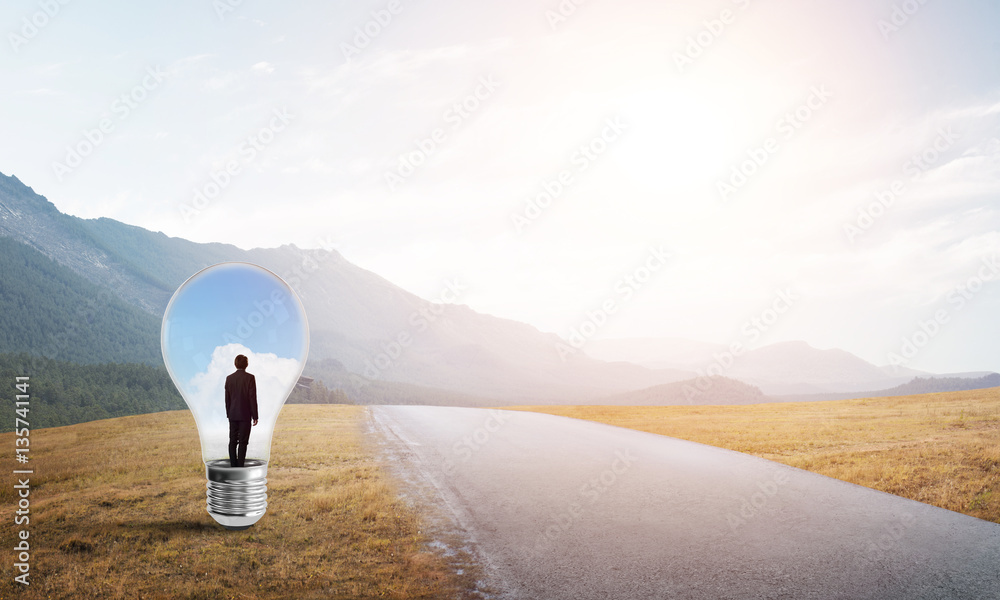 Businessman inside light bulb