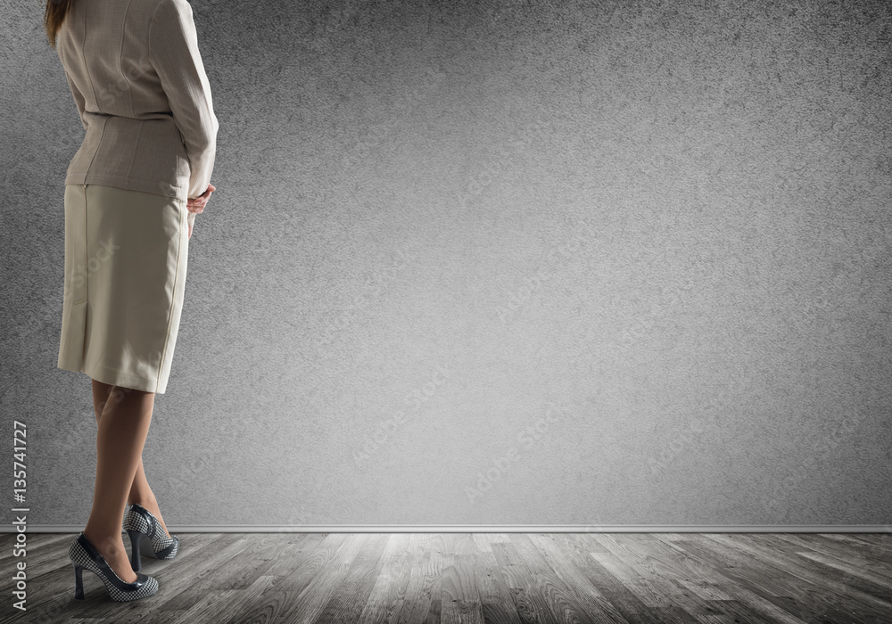 Businesswoman looking at wall