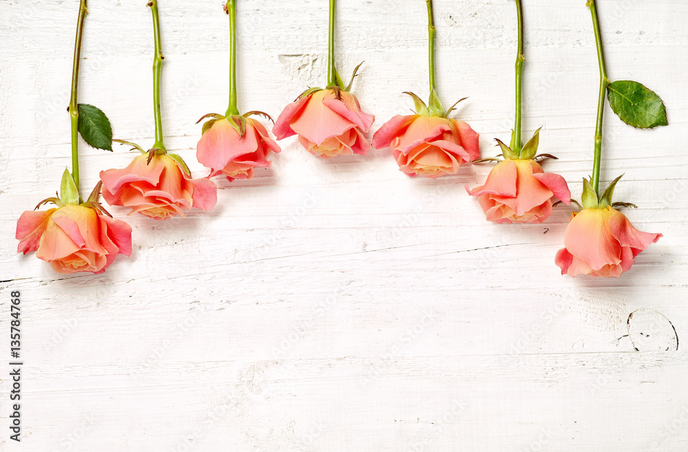 pink roses on white wooden table