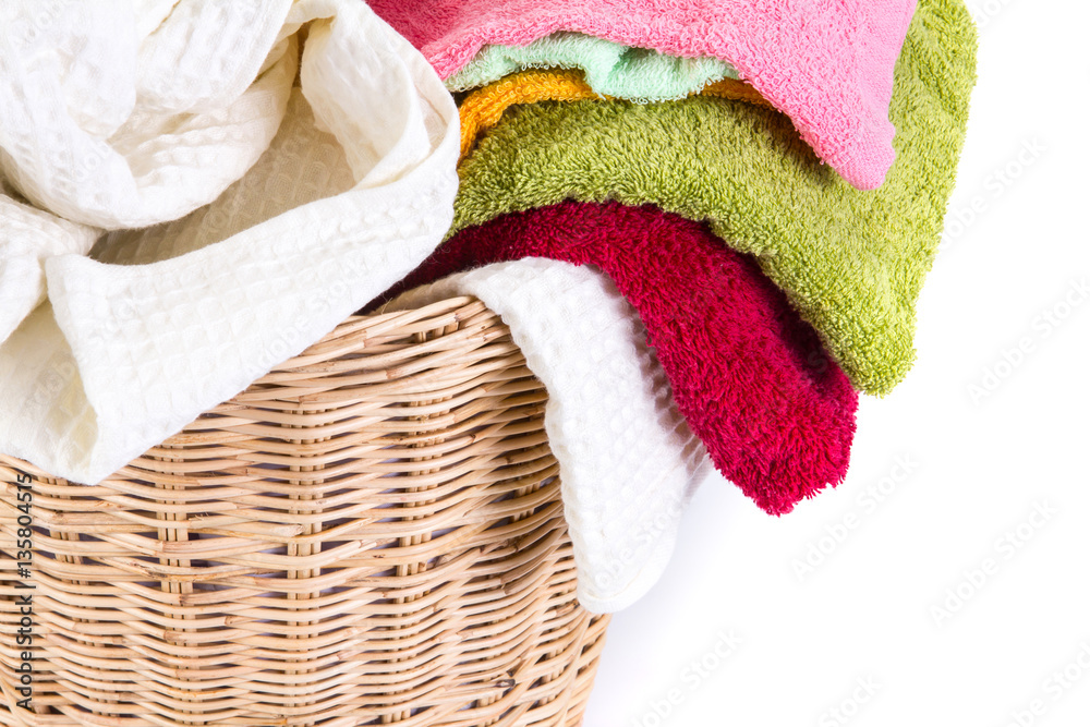 close up color mix  towel in wicker baskets on white background