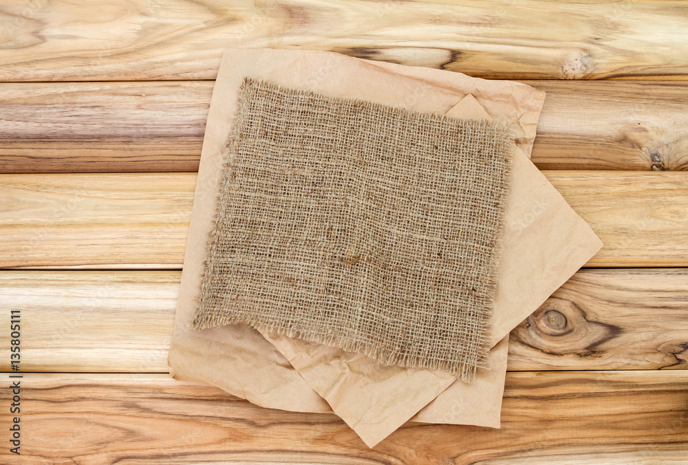 Crumbled cooking or baking paper sheet place on wooden table