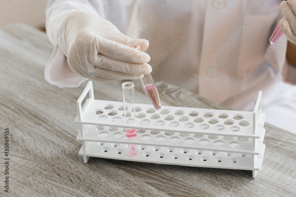 Female medical or scientific researcher using test tube on labor