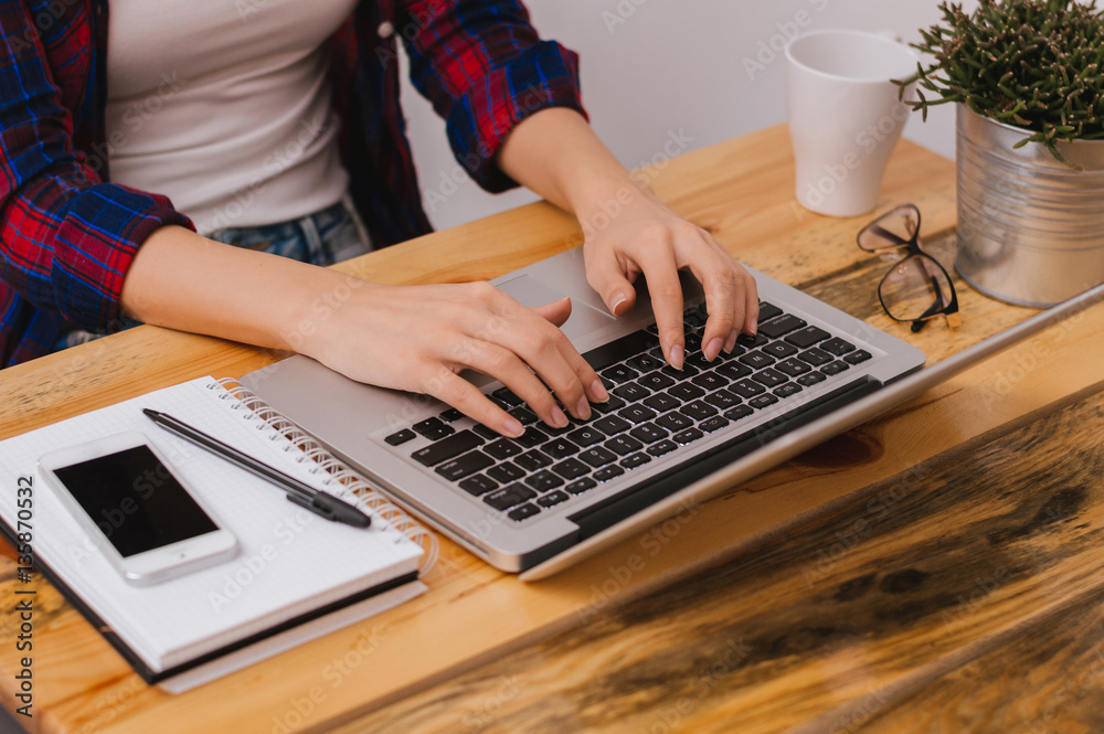 Closeup of girl hands typing on laptop keyboard. Business concep