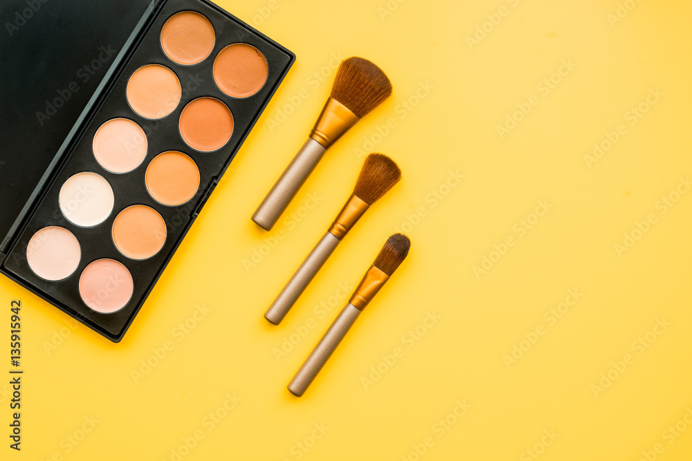 decorative cosmetics on yellow background top view