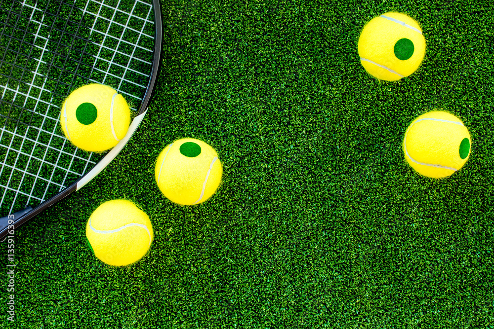 tennis racket on green background top view