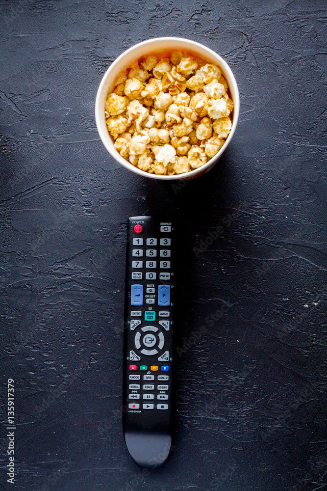 concept of watching movies with popcorn top view dark background