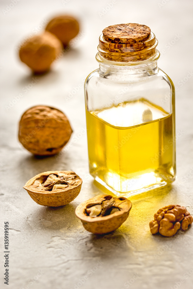 cosmetic and therapeutic walnut oil on gray background