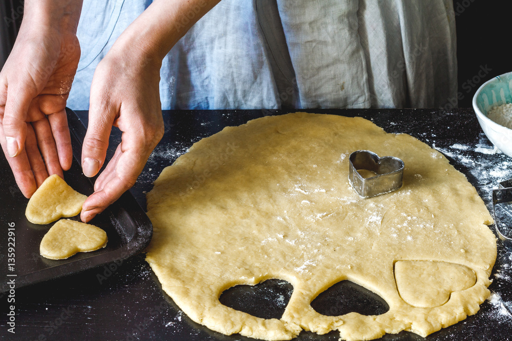 cooking homemade cookies with hands on dark background