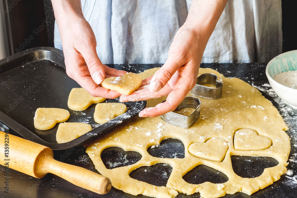 cooking homemade cookies with hands on dark background