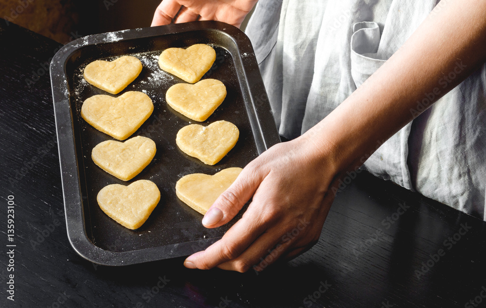 cooking homemade cookies with hands on dark background