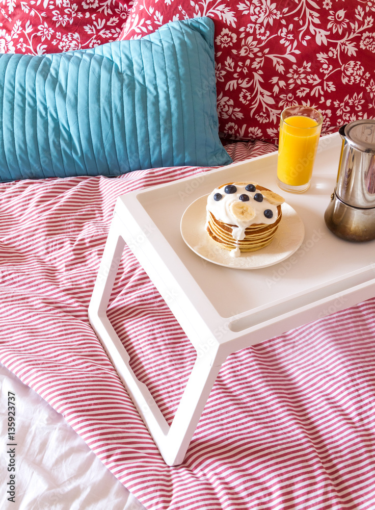 concept of breakfast in bed on tray with juice