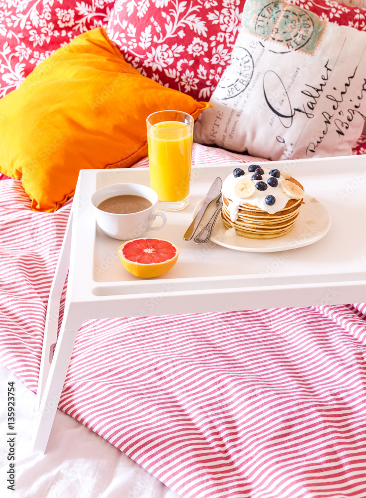 concept of breakfast in bed on tray with juice