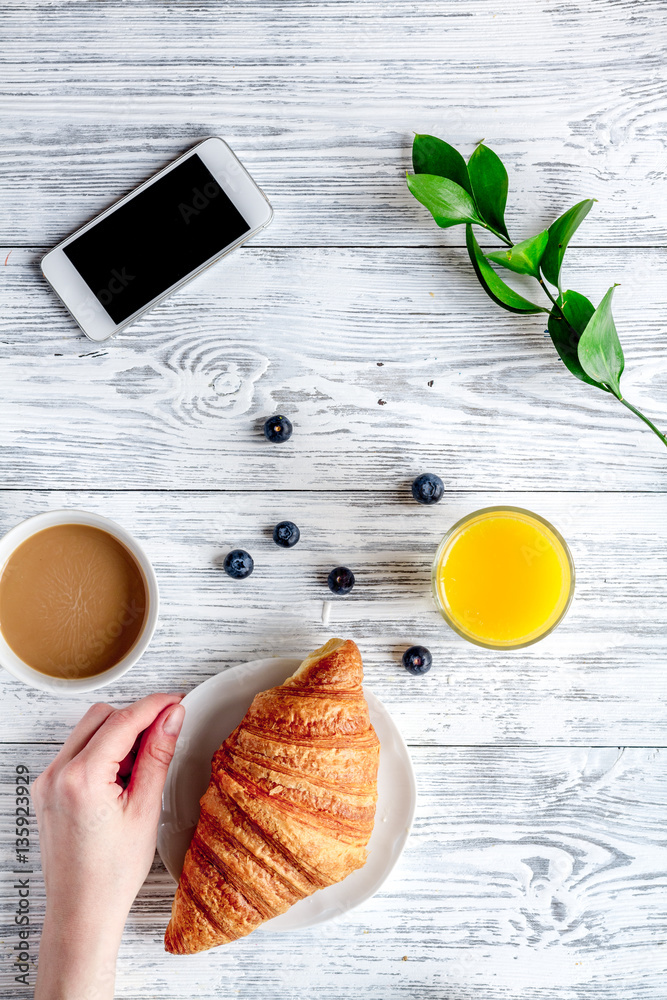 Breakfast concept with flowers on wooden background top view