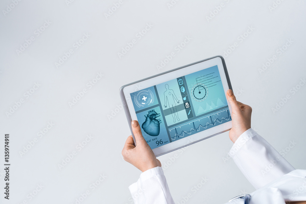 Close of female doctor hands working with tablet pc computer