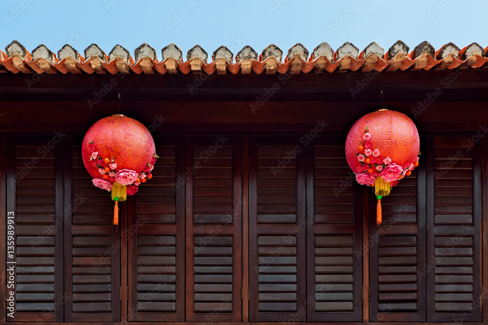 Group of traditional chinese red lanterns as decoration for China new year holidays on dark wood wal