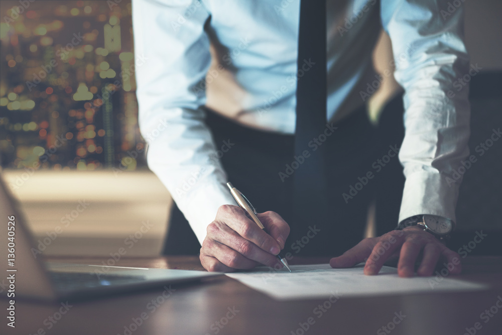 Close up business man signing contract