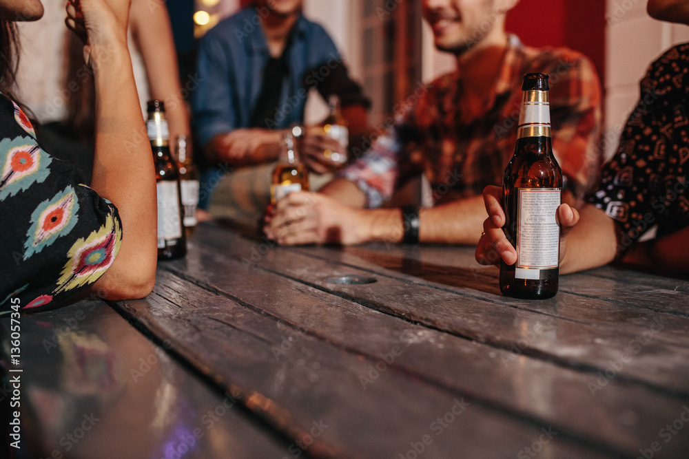 Friends sitting around a table having drinks