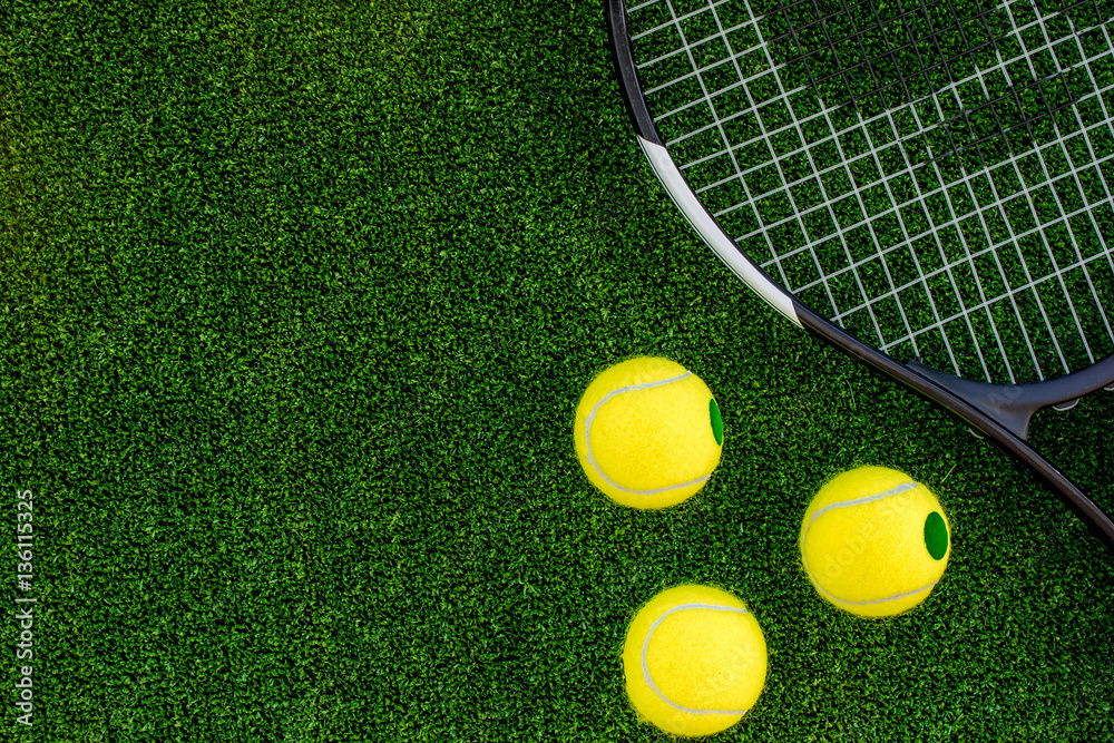 tennis racket on green background top view