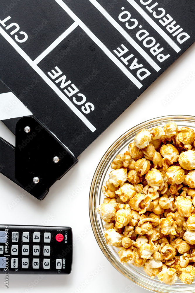 concept of watching movies with popcorn top view white background