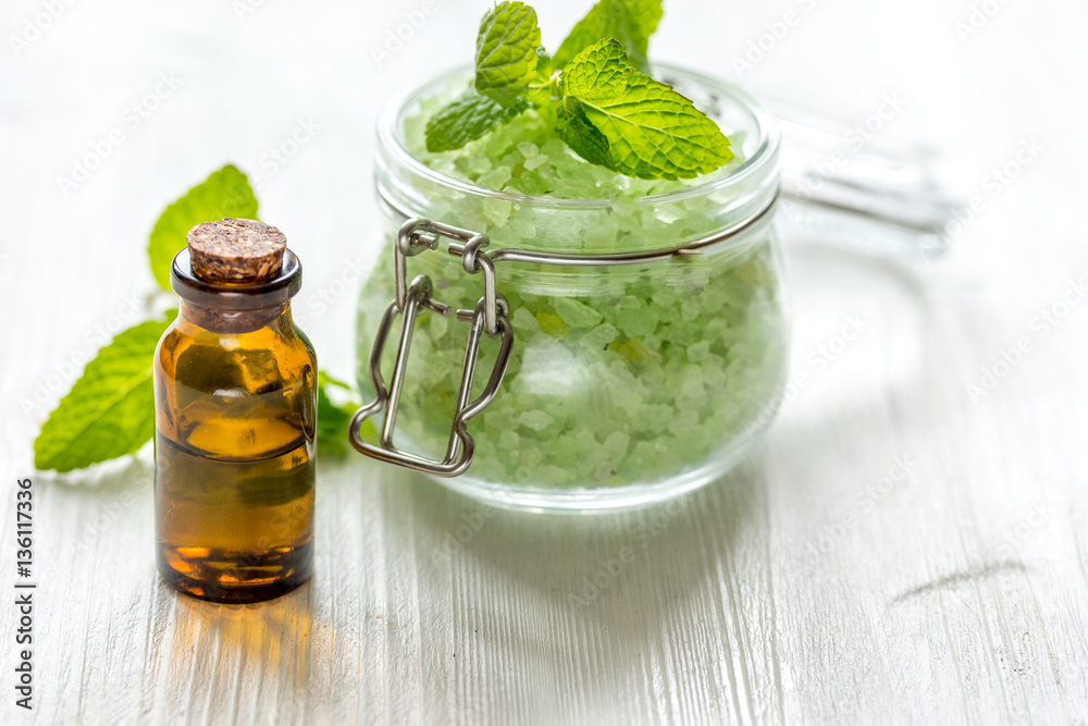 organic cosmetics with herbal extracts of mint on wooden background