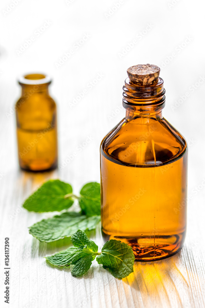 organic cosmetics with herbal extracts of mint on wooden background