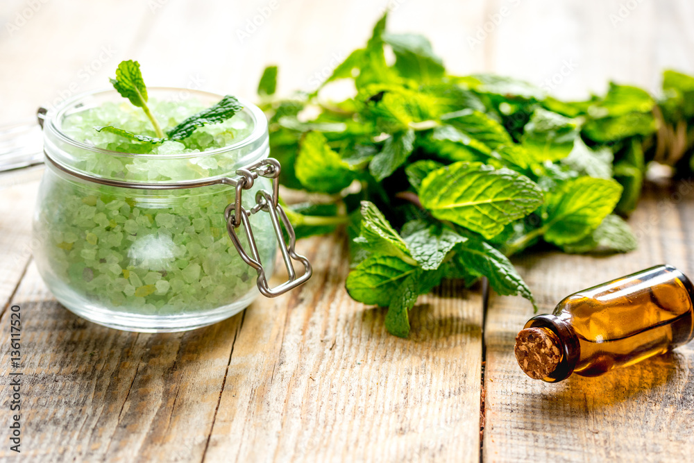 organic cosmetics with herbal extracts of mint on wooden background