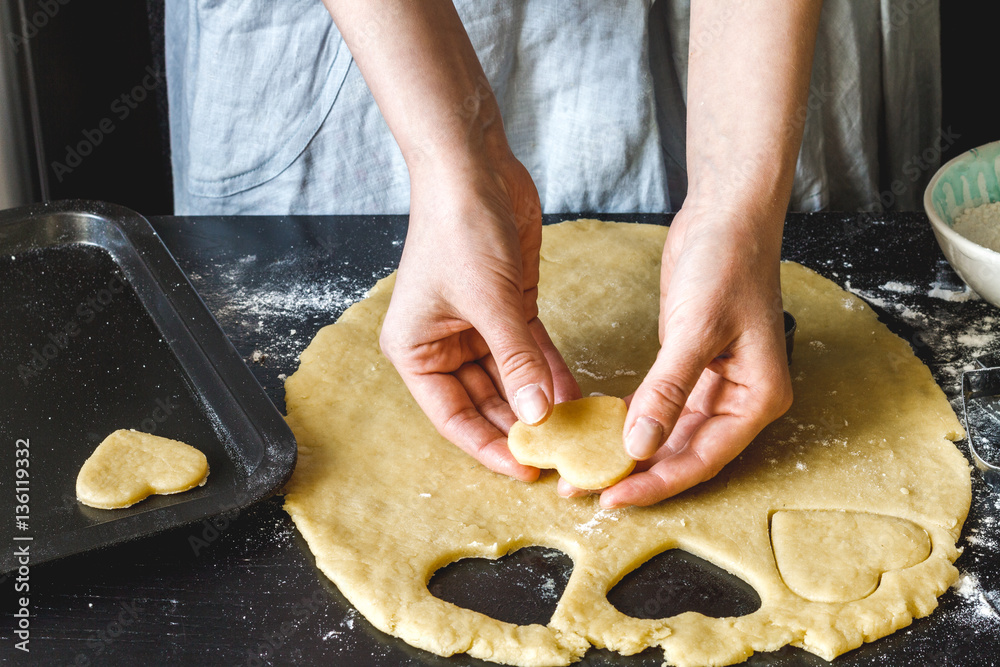 cooking homemade cookies with hands on dark background