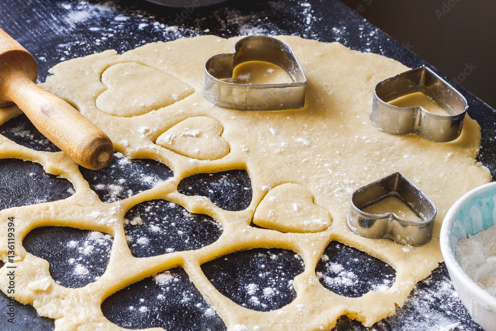 cooking homemade cookies with hands on dark background