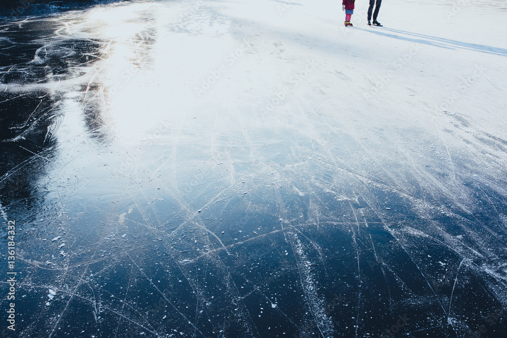 ice background. ice surface texture with skaters