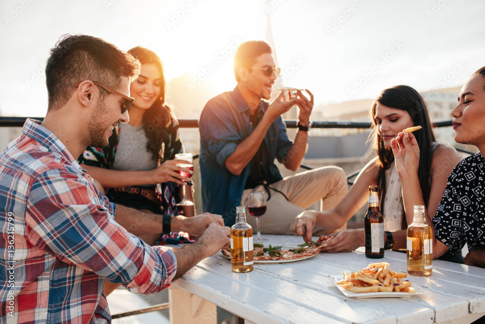 Friends partying and eating pizza