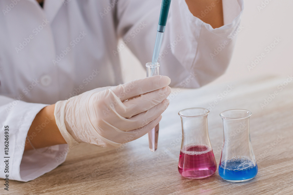 Laboratory assistant analyzing a test sample