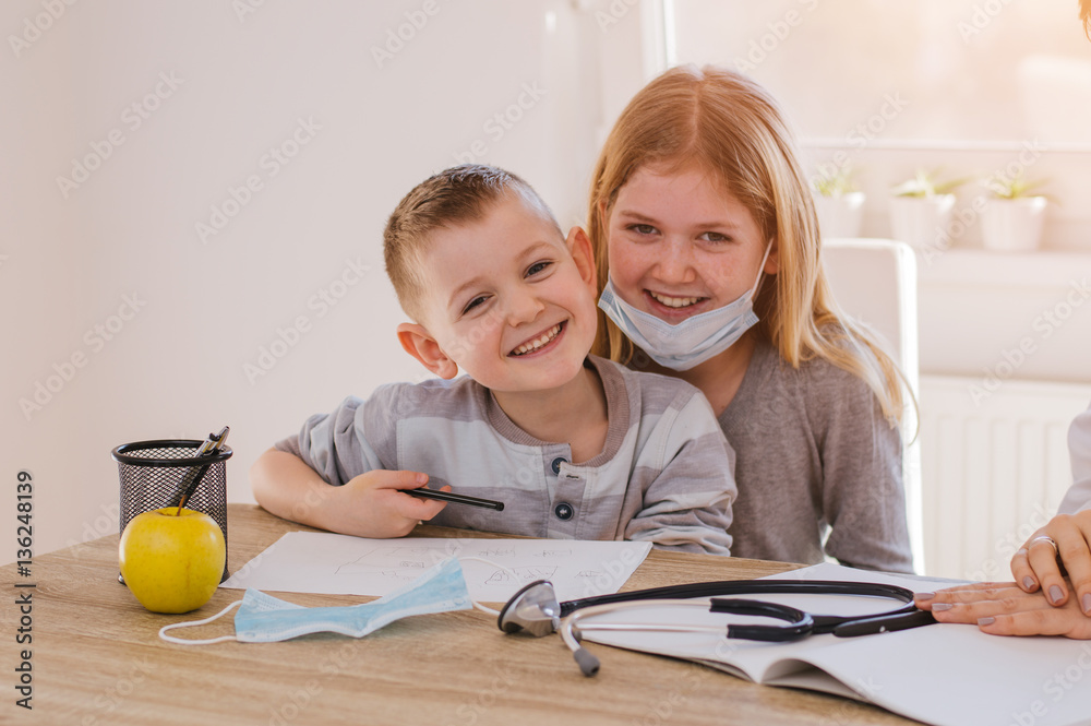 Adorable kids playing at doctors office. Lens flare