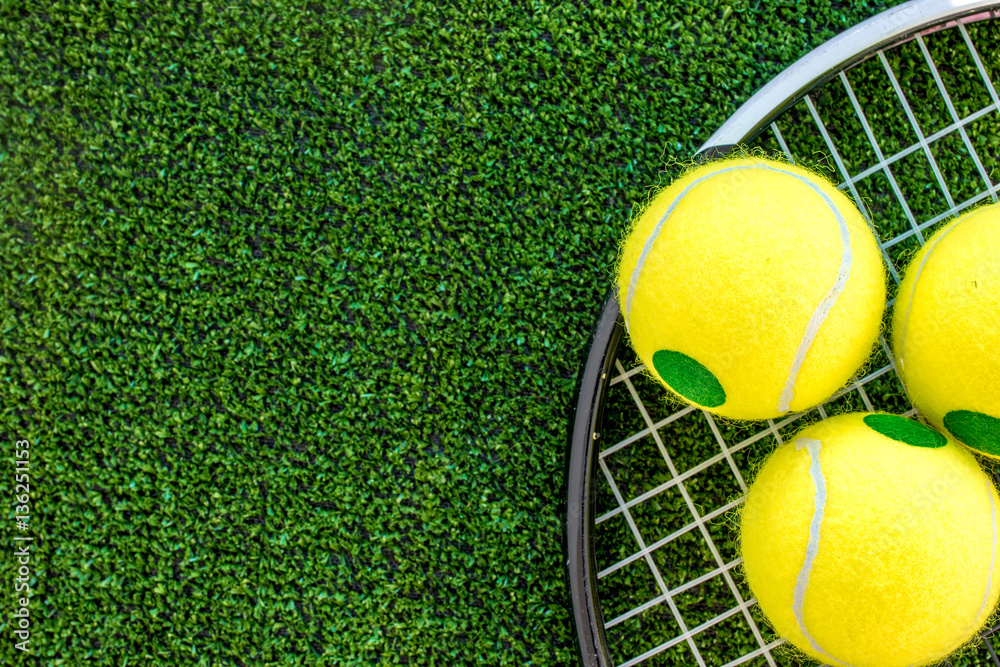 tennis racket on green background top view